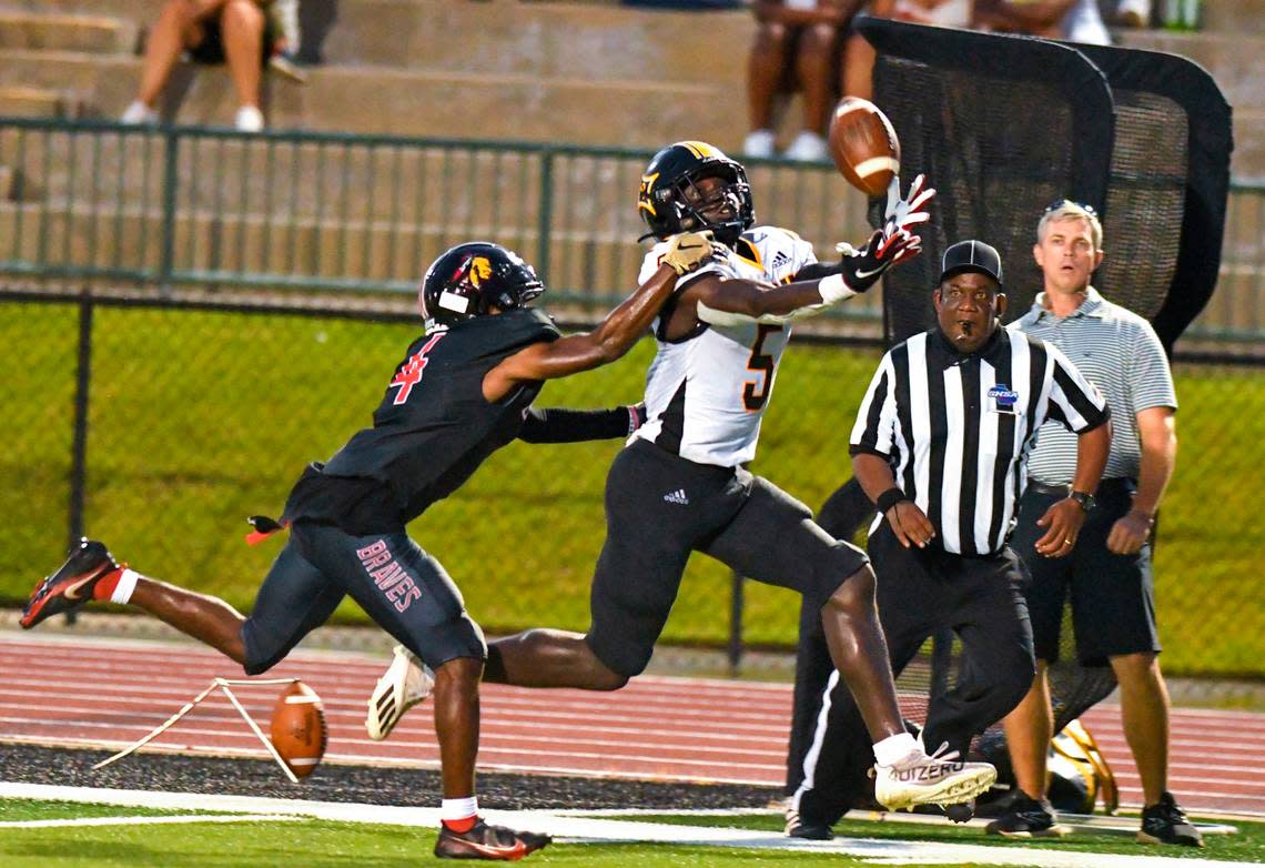 Peach County receiver Skeiler Manns (5) hauls in a deep pass from quarterback Colter Ginn (12) for a touchdown during the Trojans’ game at Baldwin Friday night. Jason Vorhees/The Telegraph