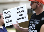 FILE - In this May 21, 2019, file photo, an abortion rights advocate hoists a sign at the Capitol in Jackson, Miss., as they rally to voice their opposition to state legislatures passing abortion bans. The Supreme Court has agreed to hear a potentially ground-breaking abortion case, and the news is energizing activists on both sides of the contentious issue. They're already girding to make abortion access a high-profile issue in next year’s midterm elections. (AP Photo/Rogelio V. Solis, File)