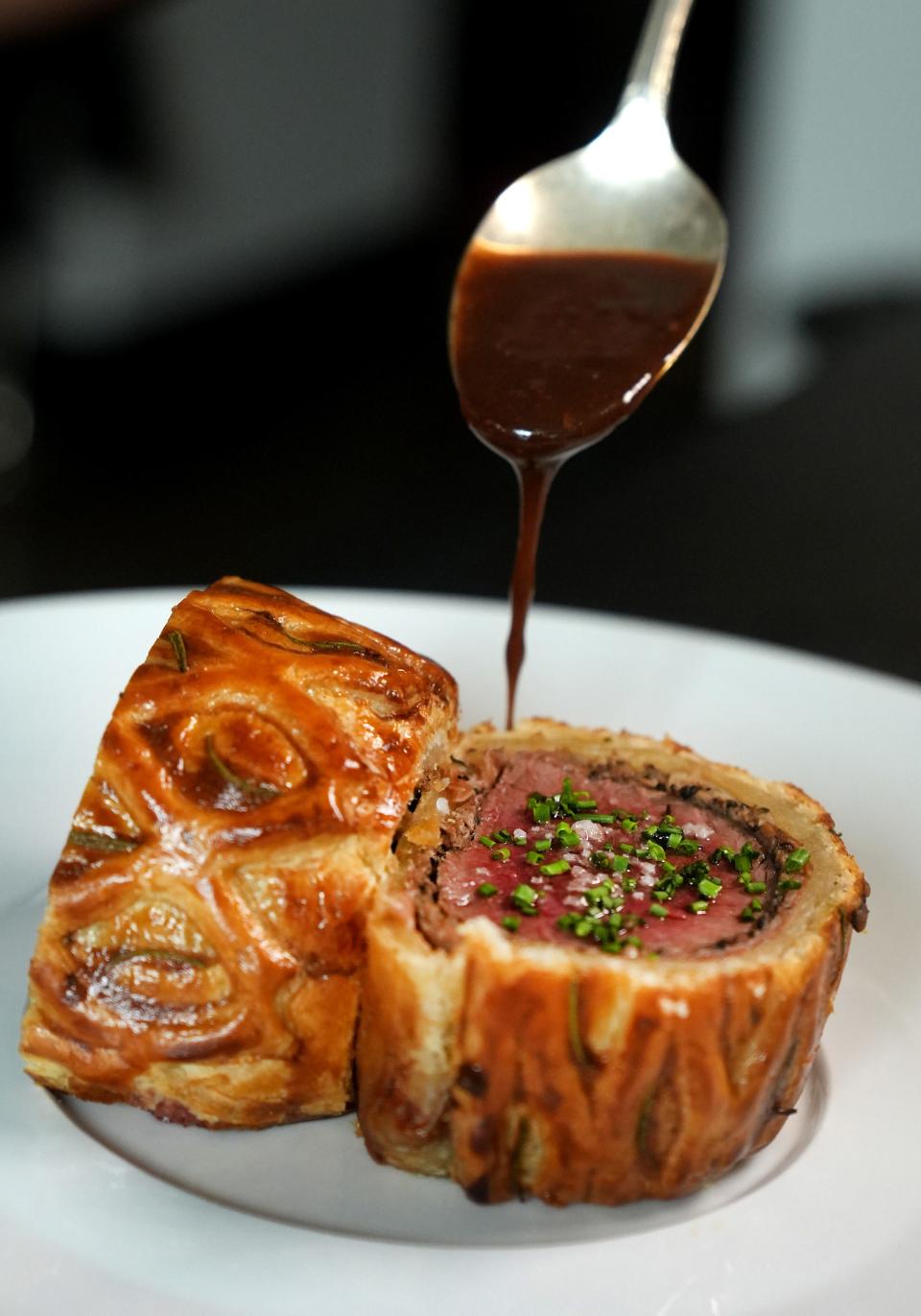 Anhelo chef Ivan Jacobo makes beef Wellington for diners at the upscale Phoenix restaurant on Oct. 26, 2022.