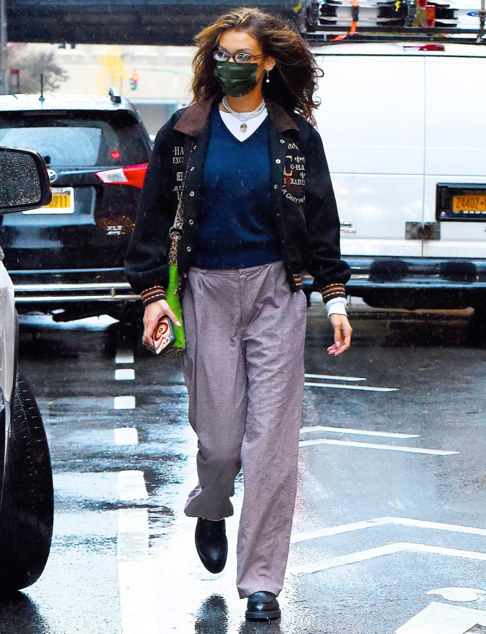 <p>Bella Hadid steps out in N.Y.C. on Thursday, wearing a black mask, lavender pants and black boots.</p>