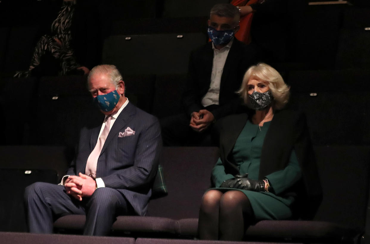 LONDON, ENGLAND - DECEMBER 03: Prince Charles, Prince of Wales, Camilla, Duchess of Cornwall and Mayor of London Sadiq Khan (behind centre) wear face masks as they watch a short rehearsal performance during their visit to Soho Theatre to celebrate London's night economy on December 03, 2020 in London, England. (Photo by Chris Jackson - WPA Pool/Getty Images)