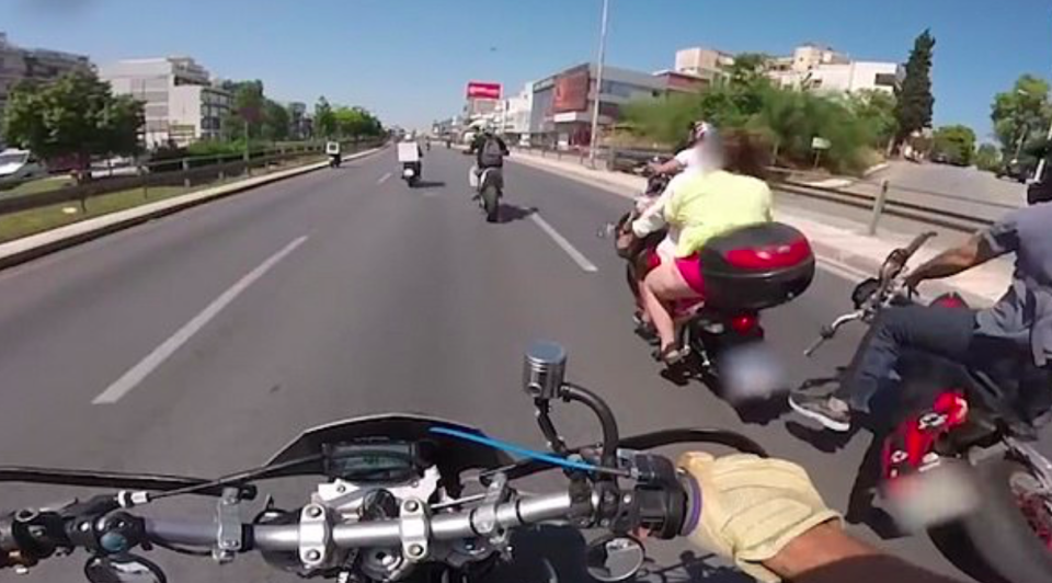 <em>The woman wearing a bikini on the motorbike fell off and skidded across a busy road in Greece (Caters)</em>