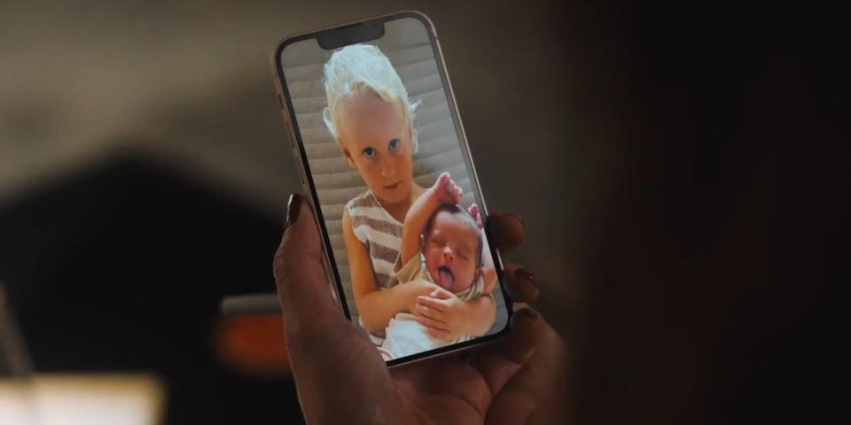 Daphne (Meghann Fahy) show a photo of her children after discussing her trainer.