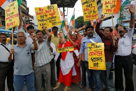 Supporters of India's main opposition Congress party shout slogans and carry an effigy depicting Uttar Pradesh state Chief Minister Yogi Adityanath during a protest in Kolkata