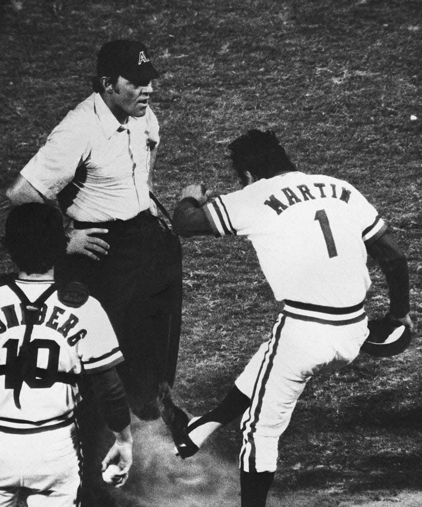 Texas Ranger manager Billy Martin kicks dirt on the feet and pants of home plate umpire Terry Cooney in third inning of game Sunday night, June 1, 1975 at Arlington Stadium, Texas. Martin was protesting the call at home when New York Yankee second baseman Fred Stanley was called safe on slide at home. Catcher Jim Sundberg is at left. Martin was ejected from the game.