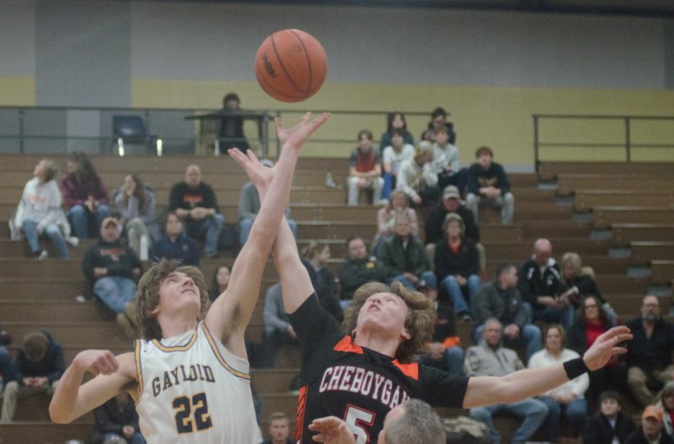 Luke Gelow (22) and Caden Garner (5) jump for the opening tip during a boys basketball matchup between Gaylord and Cheboygan on Monday, February 13.
