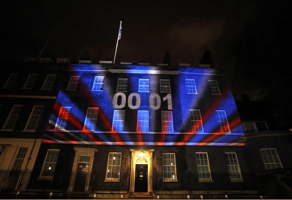 A countdown to Brexit timer and the colors of the British Union flag illuminate the exterior of 10 Downing street, the residence of the British Prime Minister, in London, England, Friday, Jan. 31, 2020. Britain officially leaves the European Union on Friday after a debilitating political period that has bitterly divided the nation since the 2016 Brexit referendum. (AP Photo/Kirsty Wigglesworth)