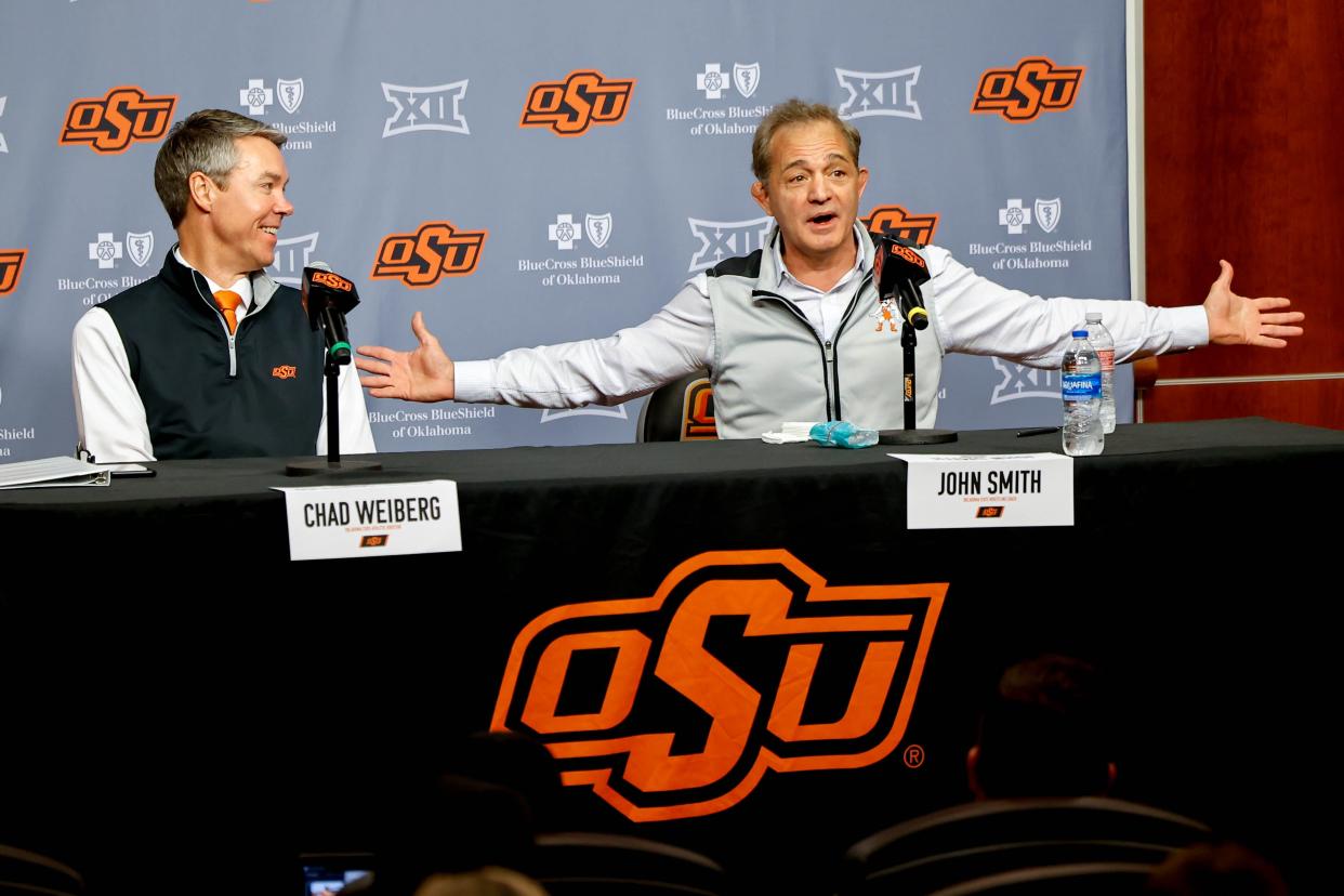 Oklahoma State wrestling coach John Smith announces his retirement stitting next to Chad Weiberg, Oklahoma State athletic director during a press conference at Oklahoma State in Stillwater, Okla., on Monday, April 15, 2024.