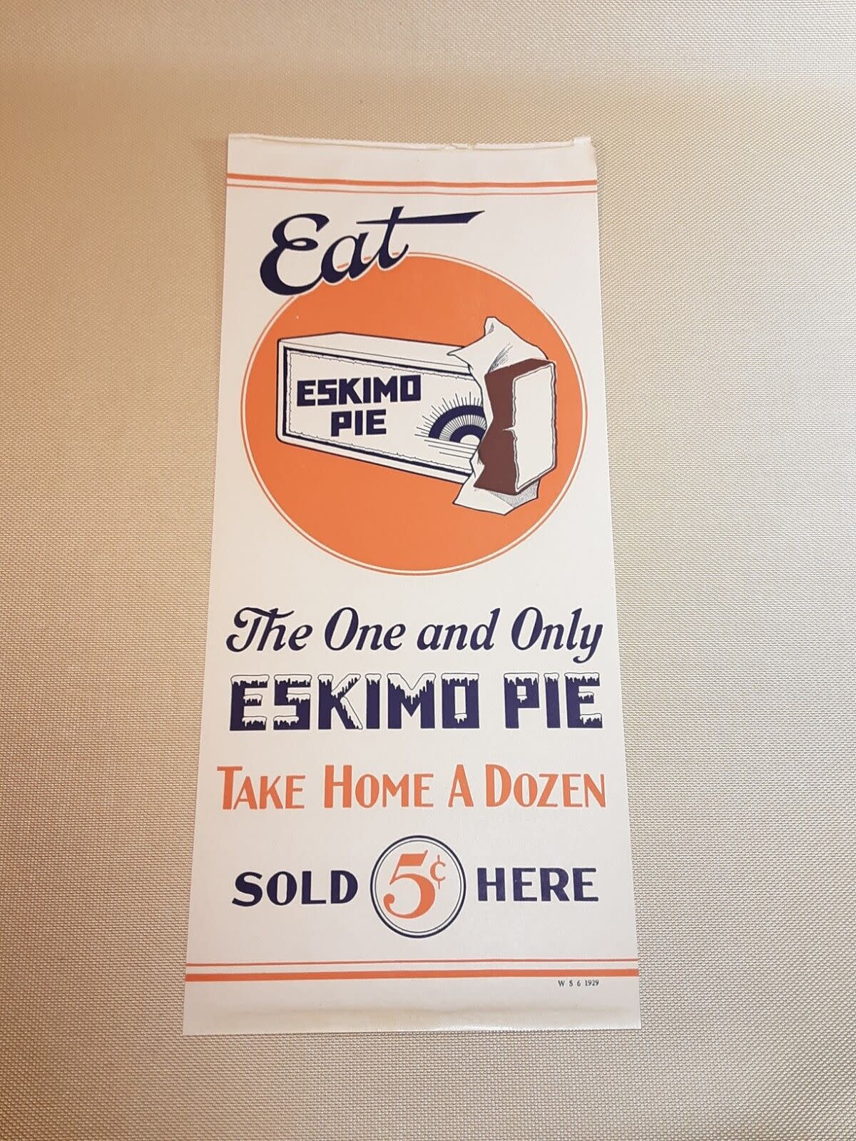 Vintage Eskimo Pie ice cream 5 cent store window paper sign ad, simple two-toned coloring on a white background, 1929