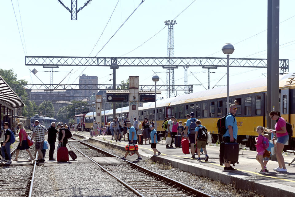 Passengers disembark from a train that arrived from the Czech Republic in Rijeka, Croatia, Wednesday, July 1, 2020. A train carrying some 500 tourists from the Czech Republic has arrived to Croatia as the country seeks to attract visitors after easing lockdown measures against the new coronavirus.(AP Photo)