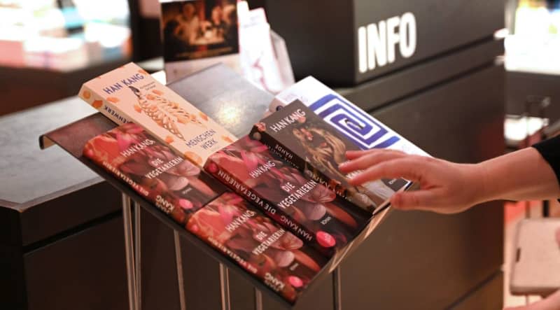 An employee places books by Nobel Prize winner Han Kang from South Korea on a book stand in the bookstore Dussmann das Kulturkaufhaus. Katharina Kausche/dpa