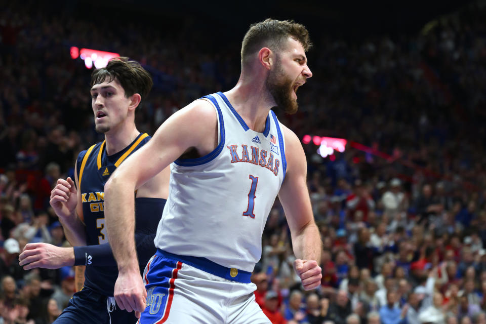 Kansas center Hunter Dickinson (1) celebrates a dunk against Kansas City guard Cameron Faas, left, during the first half of an NCAA college basketball game in Lawrence, Kan., Tuesday, Dec. 5, 2023. (AP Photo/Reed Hoffmann)