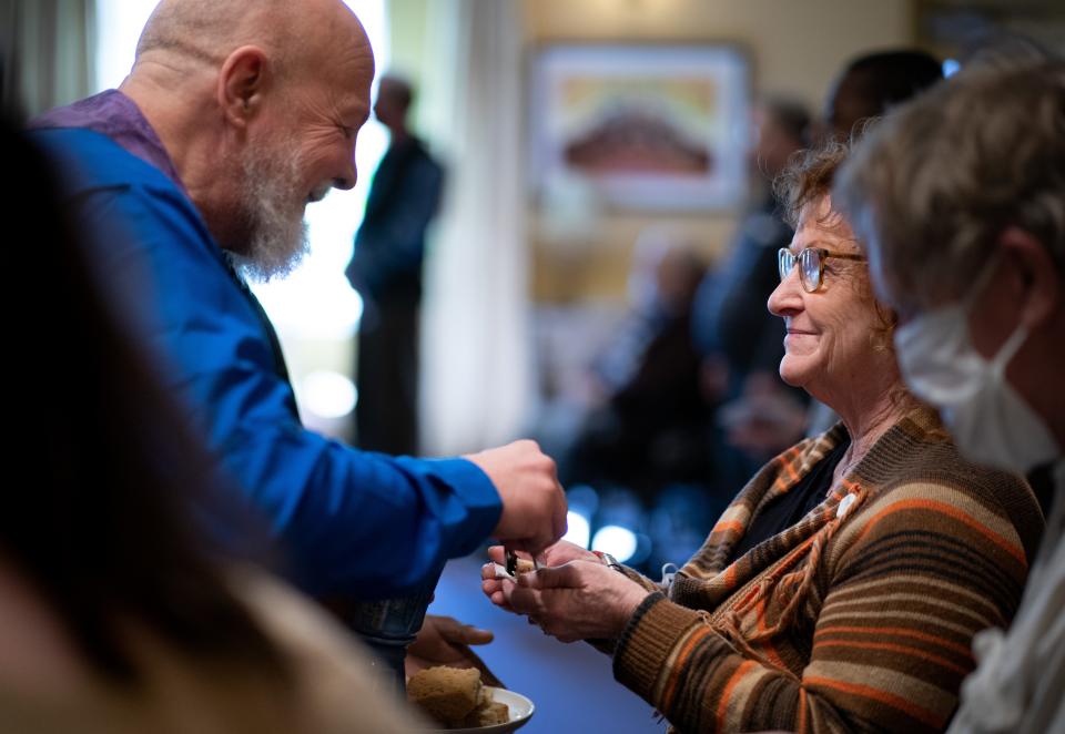 The Rev. John Feldhacker, left, pastor of Edgehill United Methodist Church, serves communion to Rebekah Walker at the Nashville, Tenn., church Sunday, Feb. 18, 2024.