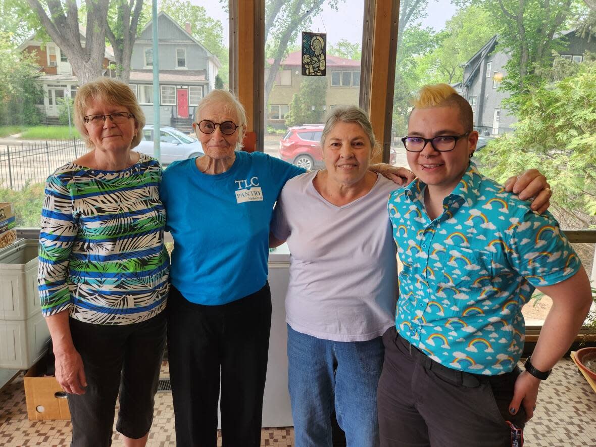 Noreen Westman, Margaret Roth, Kathy Cameron and Emmett Brown, left to right, stand in the entry way to Trinity Evangelical Lutheran Church, where they serve bagged lunches. (Samanda Brace/CBC News - image credit)