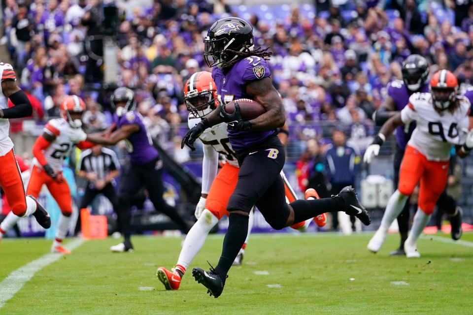 Baltimore Ravens running back Gus Edwards (35) runs past Cleveland Browns linebacker Jacob Phillips (50) to score a touchdown in the first half of an NFL football game Sunday, Oct. 23, 2022, in Baltimore. (AP Photo/Julio Cortez)