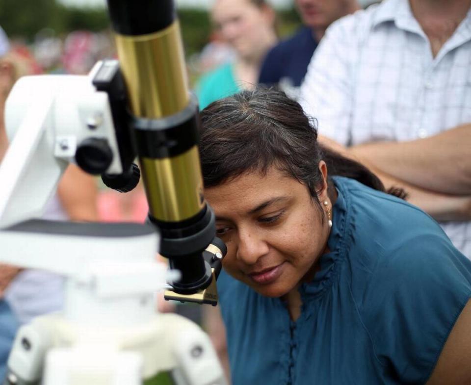 Sampurna Sattar looks at the eclipse through a telescope Monday, Aug. 21, 2017 at The Arboretum at Penn State.