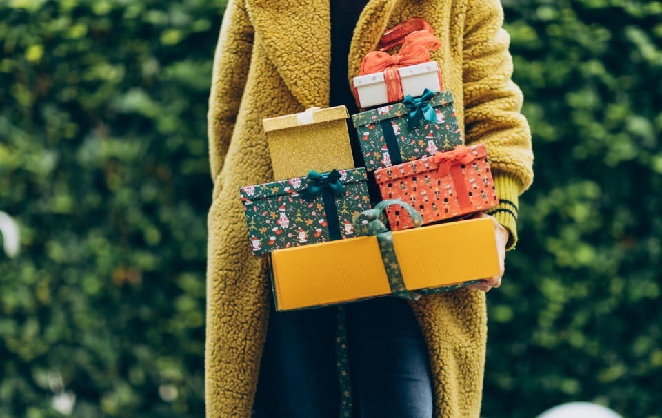 Woman holding stack of Christmas gift. New Year or Christmas concept.