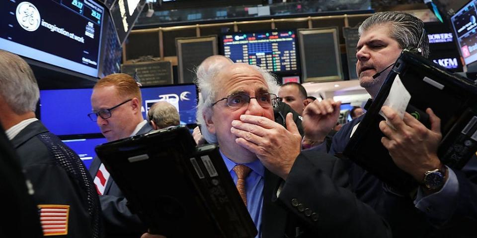 Traders work on the floor of the New York Stock Exchange (NYSE)