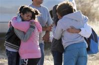 Students are reunited with family following an early morning shooting at Berrendo Middle School in Roswell, New Mexico, January 14, 2014. REUTERS/Mark Wilson/Roswell Daily Record