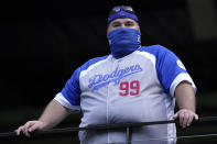 A Los Angeles Dodgers fan watches batting practice before Game 1 of the baseball World Series against the Tampa Bay Rays Tuesday, Oct. 20, 2020, in Arlington, Texas. (AP Photo/Eric Gay)