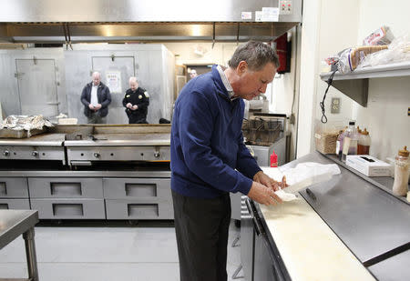 John Kasich grabs a quick breakfast after speaking at a town hall meeting at Applewood House of Pancakes in Pawleys Island, South Carolina. REUTERS/Randall Hill