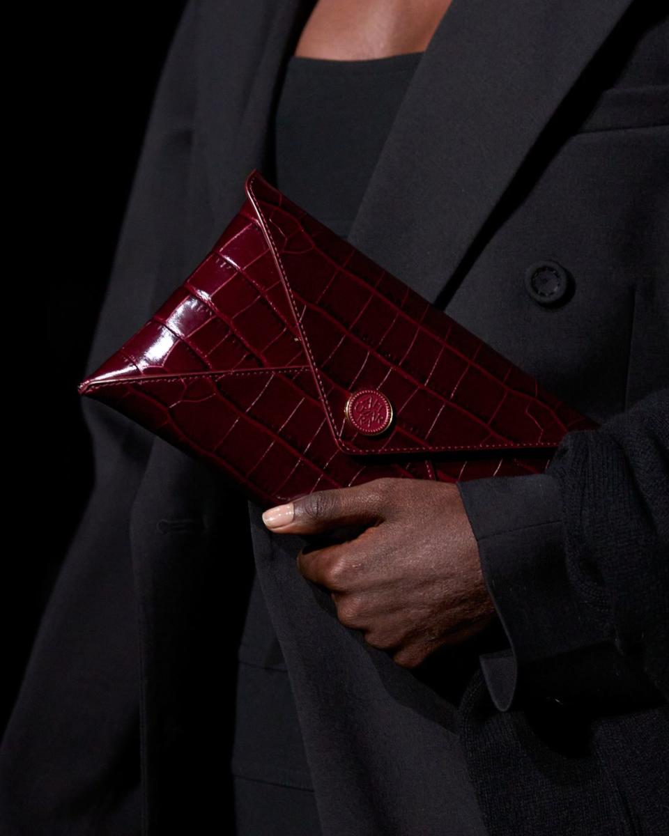 lady carrying embossed red clutch