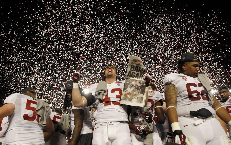 Alabama Crimson Tide's Cade Foster (C) celebrates next to teammate Brandon Ivory (R) after they defeated the Notre Dame Fighting Irish at their NCAA BCS National Championship college football game in Miami, Florida January 7, 2013. REUTERS/Jeff Haynes (UNITED STATES - Tags: SPORT FOOTBALL)