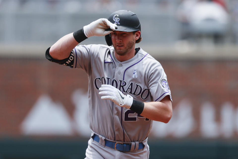 Colorado Rockies' Ryan McMahon reacts after hitting a two-run home run in the first inning of a baseball game against the Atlanta Braves, Sunday, June 18, 2023, in Atlanta. (AP Photo/Butch Dill)