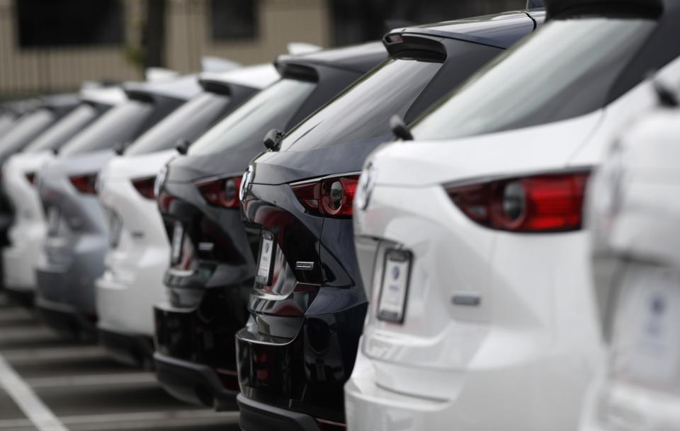 In this May 19, 2019, photo a line of unsold 2019 CX-5 sports-utility vehicles sits at a Mazda dealership in Littleton, Colo. On Wednesday, June 26, the Commerce Department releases its May report on durable goods. (AP Photo/David Zalubowski)