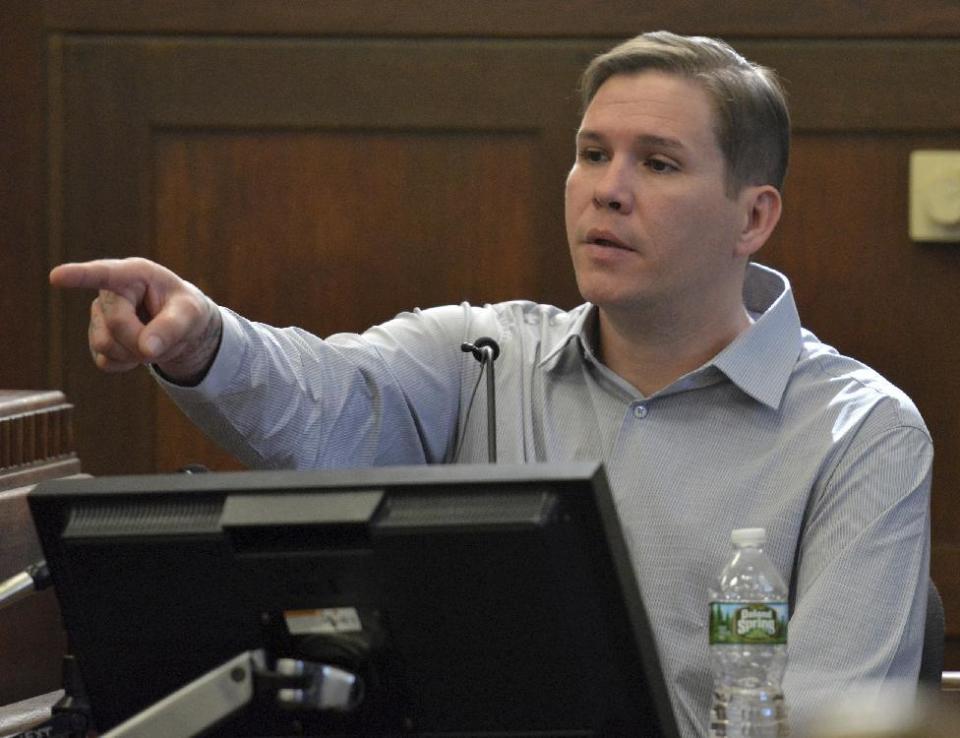 Tattoo artist David Nelson points to Former New England Patriots football player Aaron Hernandez, when asked to identify him in the courtroom during Hernandez's double murder trial in Suffolk Superior Court in Boston on Friday, March 17, 2017. Hernandez is on trial for the July 2012 killings of Daniel de Abreu and Safiro Furtado who he encountered in a Boston nightclub. The former NFL player is already serving a life sentence in the 2013 killing of semi-professional football player Odin Lloyd. (Chris Christo/The Boston Herald via AP, Pool)