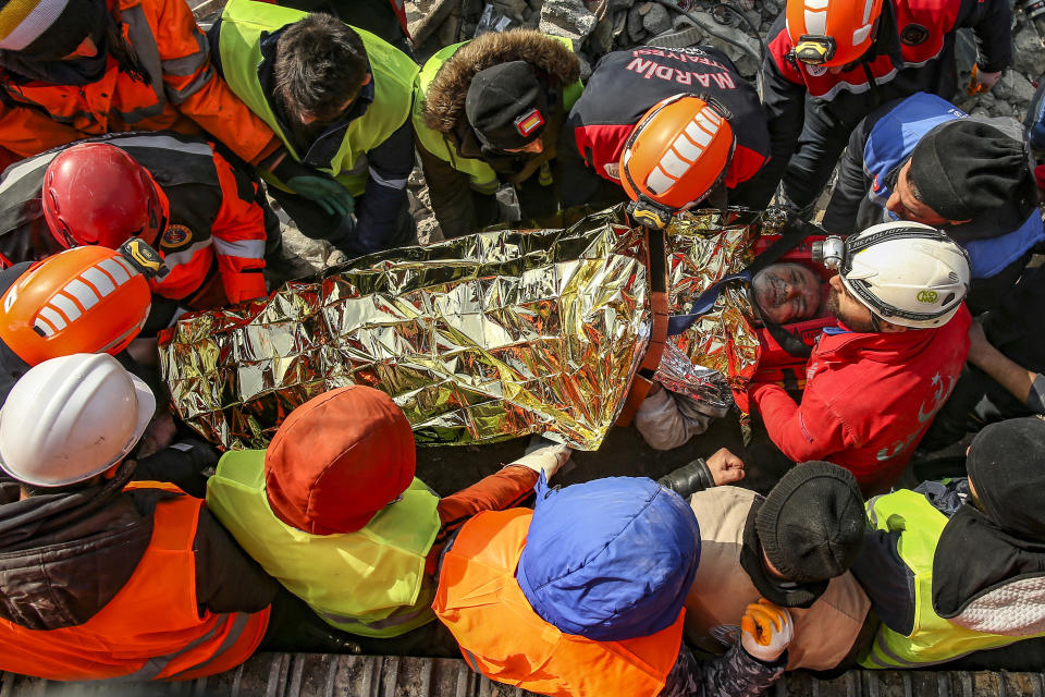 Turkish rescue workers carry Eyup Ak, 60, to an ambulance after pulling him out alive from a collapsed building, 104 hours after the earthquake, in Adiyaman, Friday, Feb. 10, 2023. Emergency crews made a series of dramatic rescues in Turkey on Friday, pulling several people, some almost unscathed, from the rubble, four days after a catastrophic earthquake killed more than 20,000. (AP Photo/Emrah Gurel)