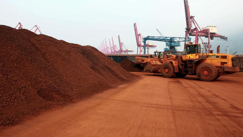 A front loader shifts soil containing rare earth minerals to be loaded at a port in Lianyungang, east China's Jiangsu province, for export in 2010. (STR/AFP via Getty Images)
