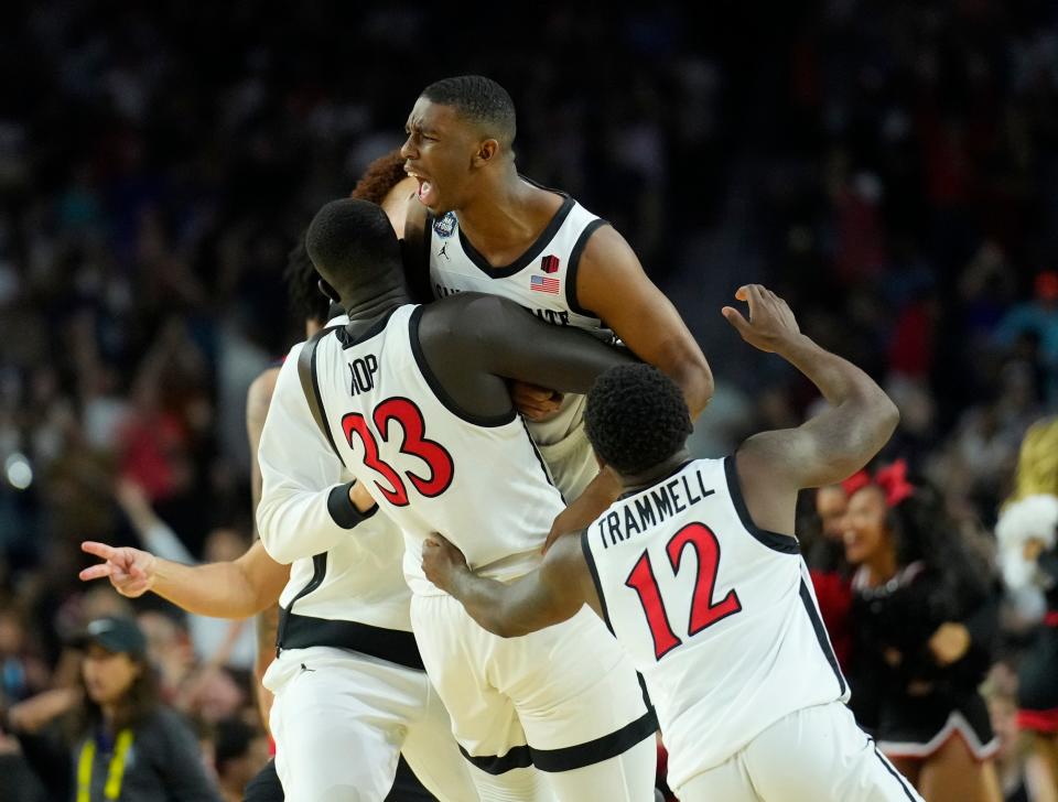 San Diego State guard Lamont Butler celebrates with teammates after hitting the game-winner as time expired.