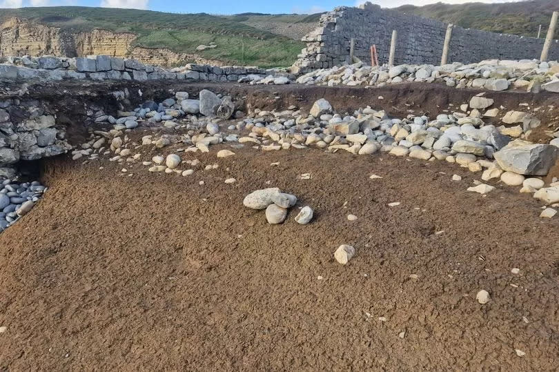 The area next to the crumbling ancient wall on the beach where they found the bones