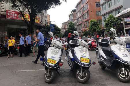 Police patrol at a market during the local dog meat festival in Yulin, Guangxi Zhuang Autonomous Region, China June 21, 2018. REUTERS/Tyrone Siu