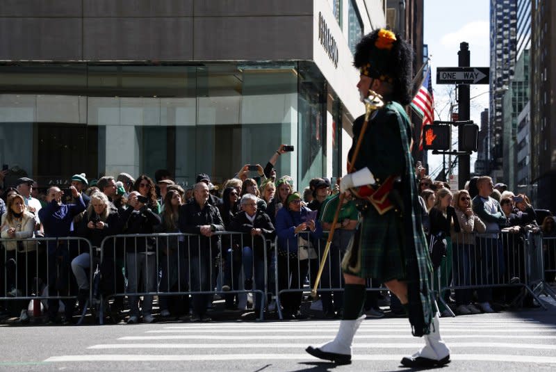 Parade goers watch as participants in the St. Patrick's Day Parade march up Fifth Avenue in New York City on Saturday. Photo by John Angelillo/UPI