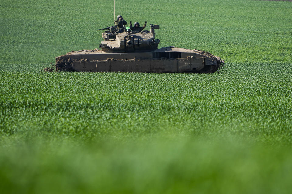 An Israeli tank drives to a position on the border with the Gaza Strip, as seen from southern Israel, Tuesday, Jan. 30, 2024. (AP Photo/Ariel Schalit)