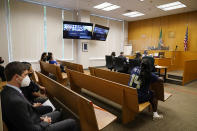 Ashley Sherman, wife of former Seattle Seahawks and San Francisco 49ers NFL football star Richard Sherman, sits with her attorney Mark Middaugh, left, at the back of a King County District Court courtroom during a hearing about her husband Thursday, July 15, 2021, in Seattle. Richard Sherman was arrested early Wednesday after police said he crashed his car in a construction zone and then tried to break into his in-laws' home in the Seattle suburb of Redmond, Wash. (AP Photo/Elaine Thompson)