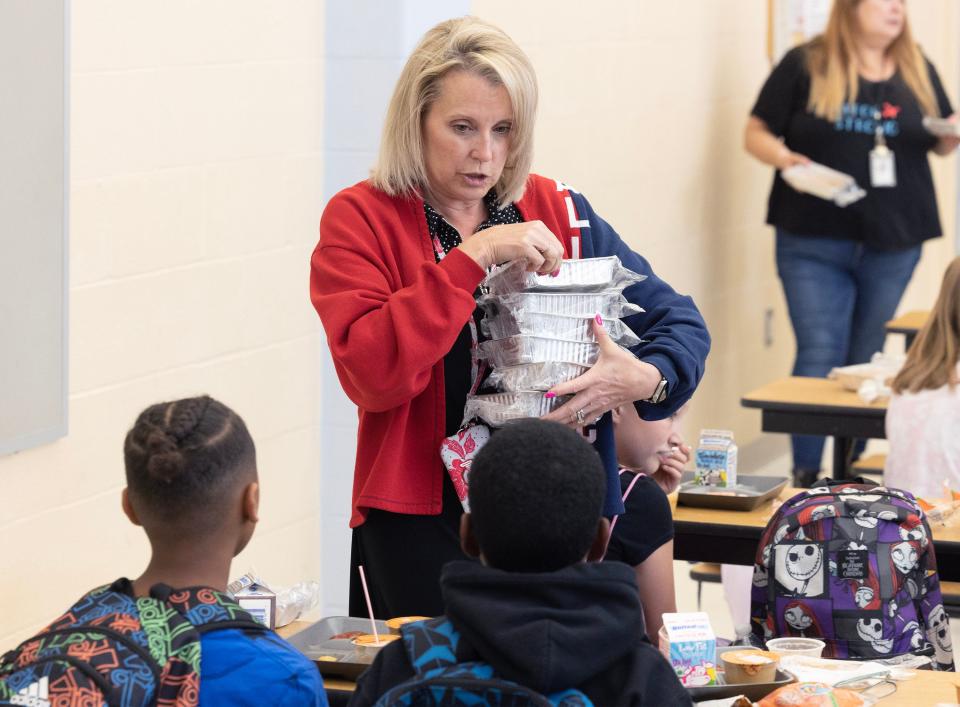 Fifth grade teacher Jodi Weaver passes out lunches at Alliance Elementary School. Alliance City Schools is offering free breakfast and free lunch to any child ages 18 and younger as part of Ohio's Summer Food Service Program.
