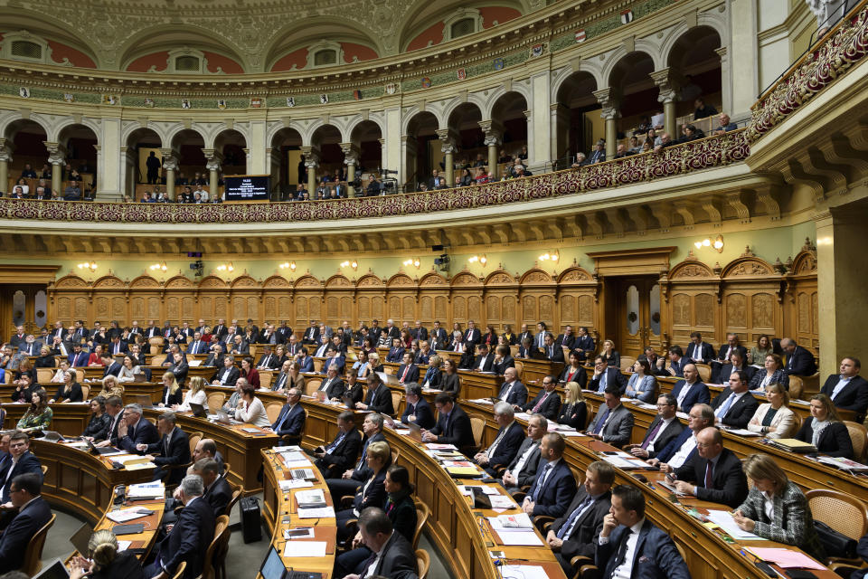 FILE - Members of the parliament sit in the National Council hall during the Federal council elections, in Bern, Switzerland, on December 11, 2019. On Sunday Oct. 22, 2023 Swiss voters elect the two houses of parliament, an exercise every four years that will ultimately shape the future composition of the Alpine country’s executive branch: The Federal Council. (Anthony Anex/Keystone via AP, File)