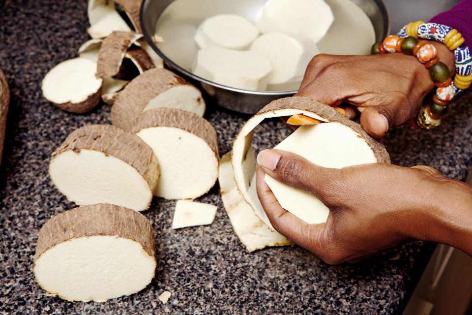 Seriki peels large discs of Ghana yam, which she cubes, steams, and tosses with butter for a simple side dish.