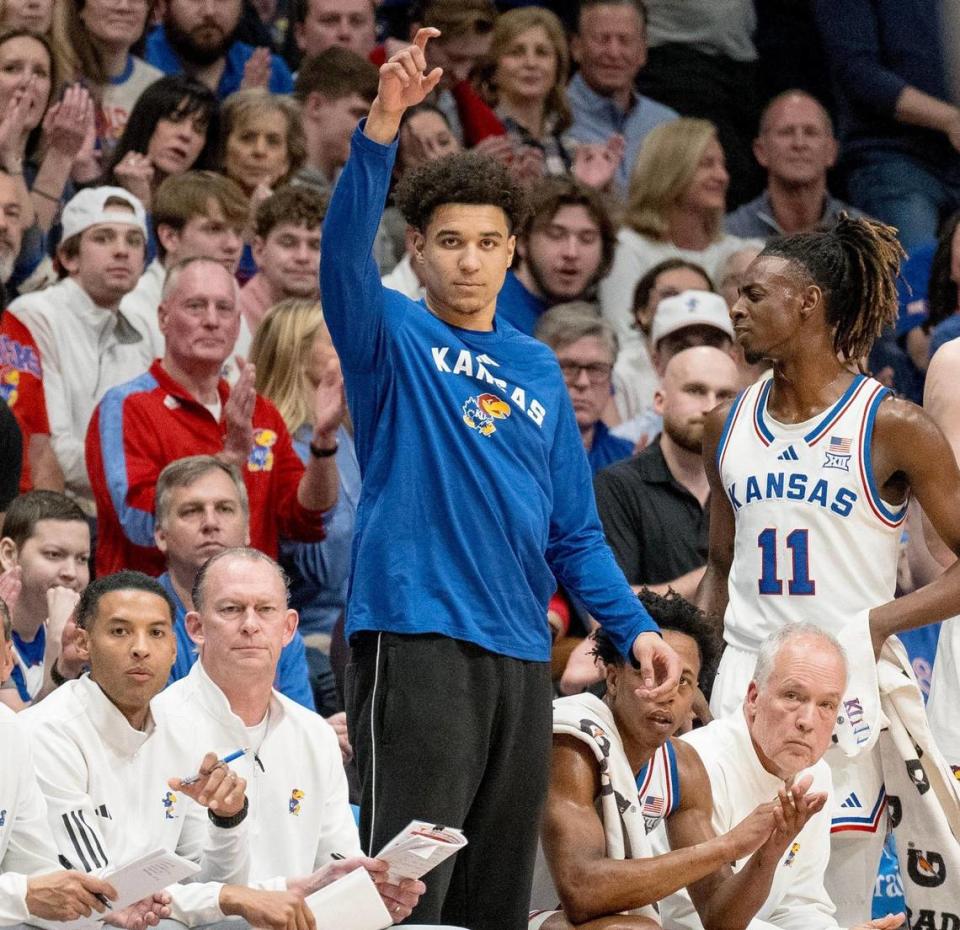 Kansas Jayhawks guard Kevin McCullar Jr. points to a teammate while standing on the sideline during an NCAA basketball game against the Texas Longhorns on Saturday, Feb. 24, 2024, in Lawrence.