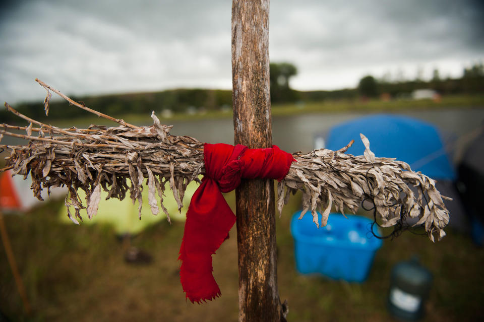 <p>A sage tie, used by some Native American tribes to clear negative energy or spirits, hangs at the Seven Councils camp on the banks of the Cannonball River in North Dakota amid protests against the Dakota Access pipeline on Sept. 7, 2016. (Photo: Andrew Cullen/Reuters) </p>