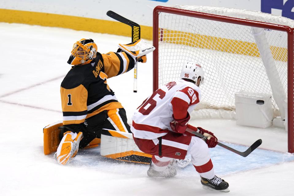 Detroit Red Wings' Jake Walman backhands a shot past Pittsburgh Penguins goaltender Casey DeSmith for an overtime goal at PPG Paints Arena in Pittsburgh on Wednesday, Dec. 28, 2022.