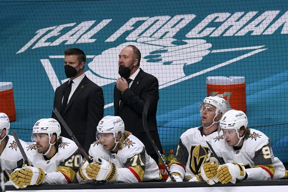 Vegas Golden Knights coach Peter DeBoer, top right, watches from the bench during the second period of the team's NHL hockey game against the San Jose Sharks in San Jose, Calif., Saturday, March 6, 2021. (AP Photo/Jeff Chiu)