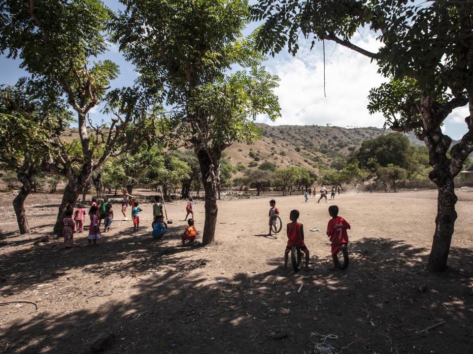 Kids playing football on Komodo Island.