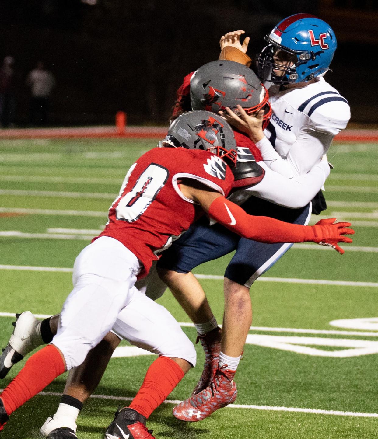 Liberty Creek's Brian Rager (18) is sacked by East Nashville's Malik Bolling (51) and Tion Curry (10) during their game at East Nashville High School in Nashville, Tenn., Friday, Nov. 17, 2023.