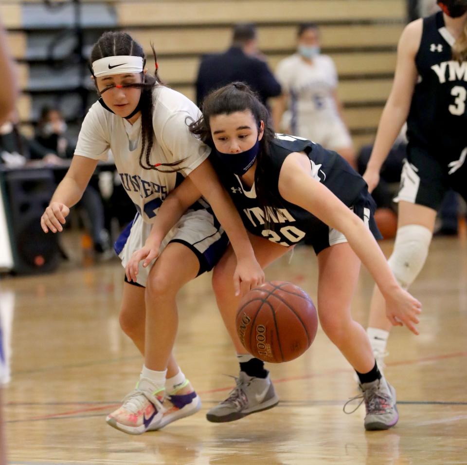 Alyssa Febres of Saunders and Keelyn Connaughton of the Yonkers Montessori Academy battle for a loose ball during the Yonkers City Tournament championship basketball  game at the Cross Hill Academy in Yonkers March 9, 2021. Saunders defeated YMA 48-38.