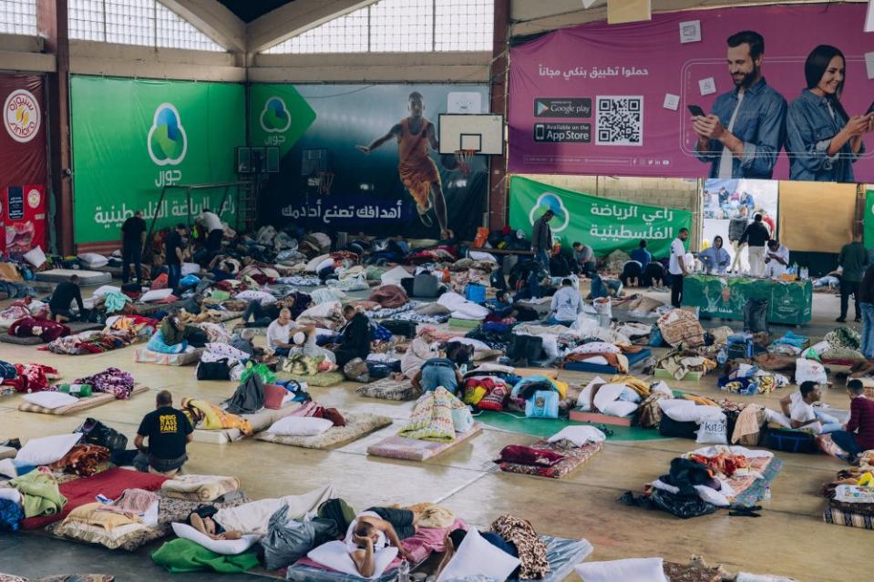 Over 400 Palestinians from Gaza find refuge on Oct. 12 at Ramallah’s Nadi al-Sarryieh, a sports club that was transformed into a shelter. ⁣⁣Workers were welcomed by Palestinian volunteers in Ramallah who tirelessly provide mattresses, food, medicine, a mobile salon, and unwavering solidarity. Thousands of other Palestinian workers from Gaza have also sought refuge in various locations within the West Bank. <span class="copyright">Maen Hammad</span>