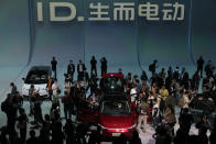 FILE - Attendees take a close look at the Volkswagen ID.7 Vizzion, a new electric flagship sedan during a world premiere on the eve of the Auto Shanghai 2023 show in Shanghai, China on April 17, 2023. (AP Photo/Ng Han Guan, File)